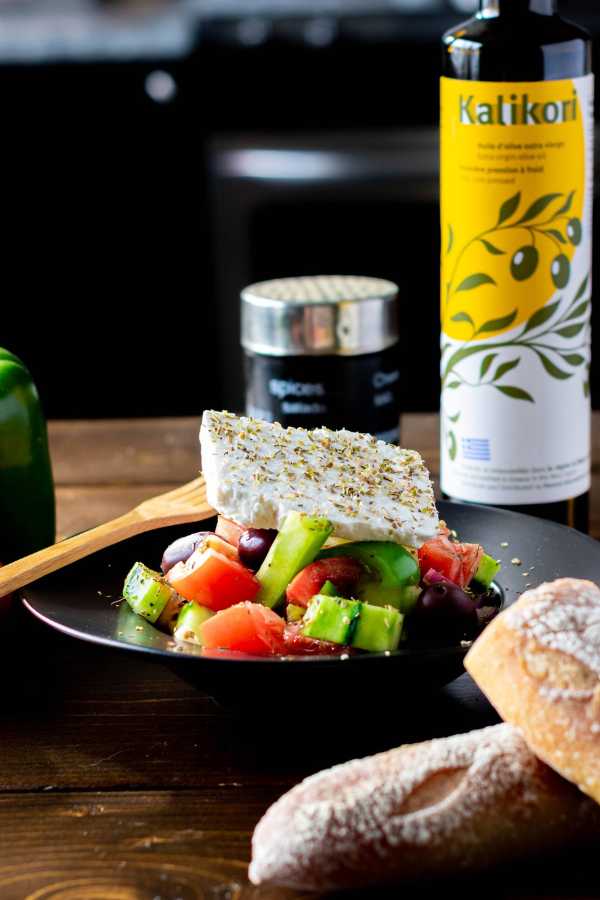greek salad on a plate with feta and oil